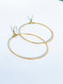 2 1/2" X 1 1/2" Dainty, oval hoop earrings that hang down from a lever back ear wire