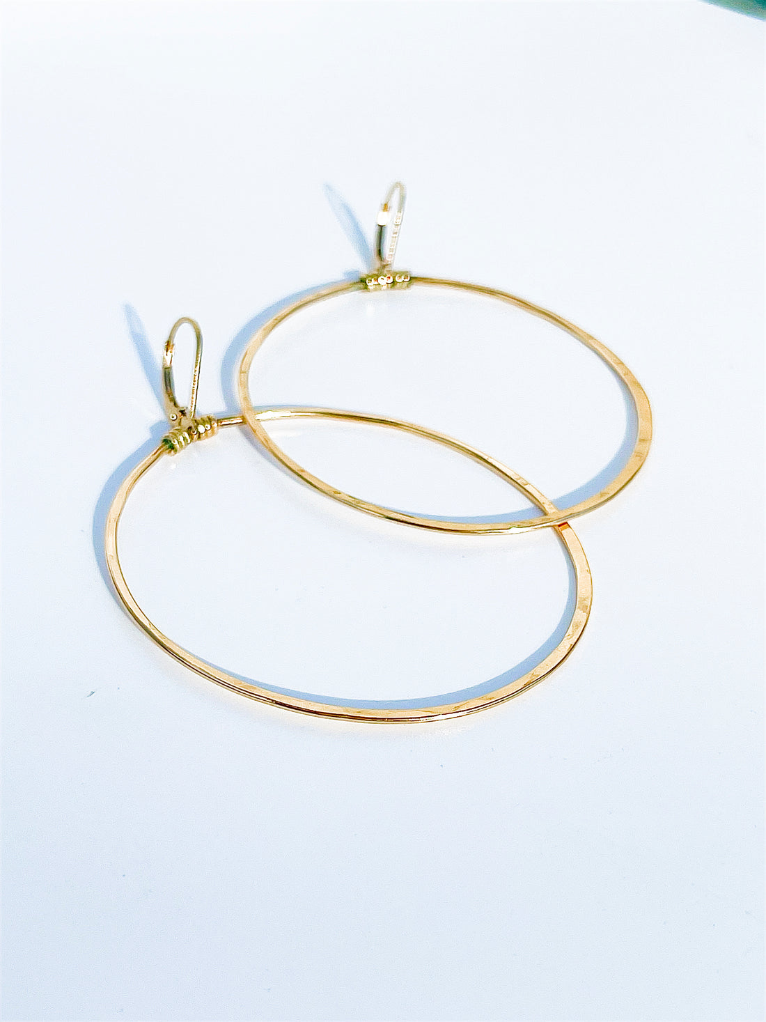 2 1/2" X 1 1/2" Dainty, oval hoop earrings that hang down from a lever back ear wire